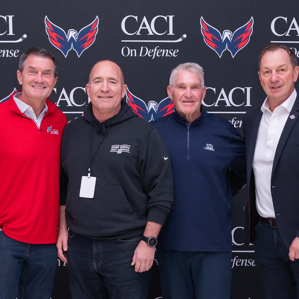 Caps alumni Alan May, Craig Laughlin and Peter Bondra pose with Good Dogs for Great Americans Ambassador Mike Shields.